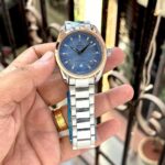 Omega Seamaster Aqua Terra luxury watch for men featuring 3D textured blue dial, rose gold bezel, stainless steel strap, and sweep movement.