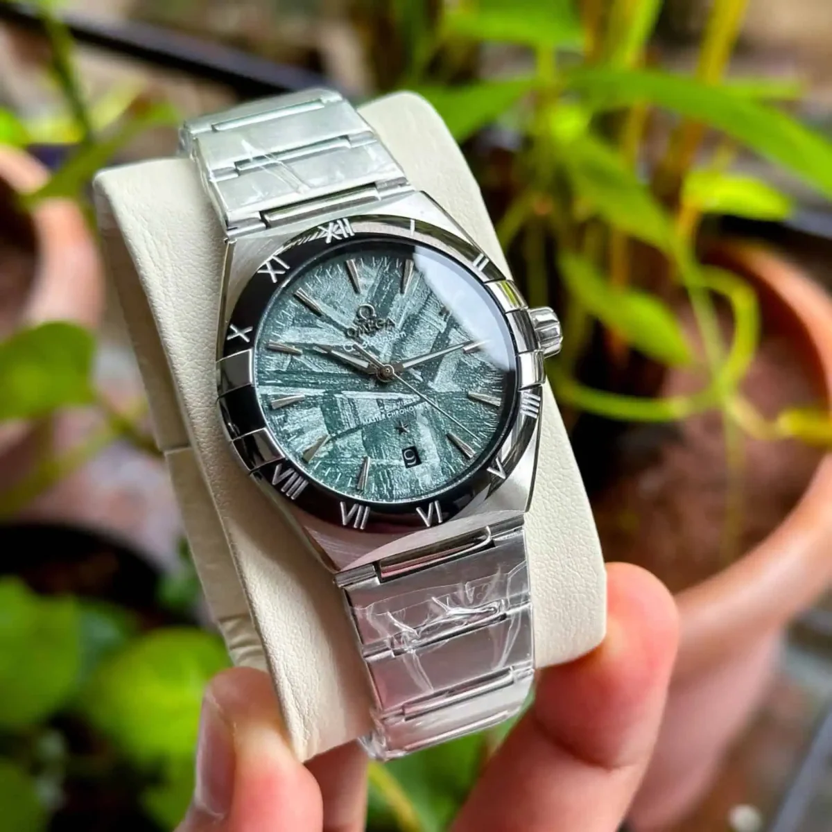 Omega Constellation Meteorite Dial Watch – 41mm Green Dial with Black Bezel – Automatic Close view on man fingers