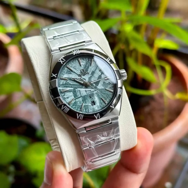 Omega Constellation Meteorite Dial Watch – 41mm Green Dial with Black Bezel – Automatic Close view on man fingers