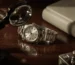 Rolex watch on a wooden table with watch tools