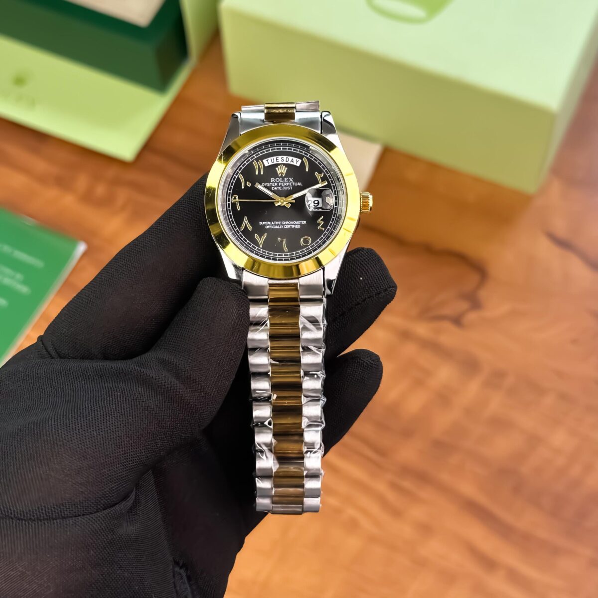 Rolex Day-Date Men’s Watch in 7A Premium Quality with black Arabic dial, gold two-tone bracelet, and quartz movement.