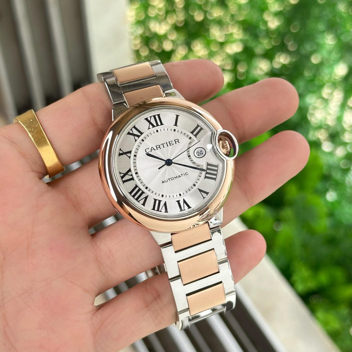 Cartier Ballon Bleu Men’s 42mm with white dial, two-tone stainless steel strap, date counter, and Japanese automatic movement.