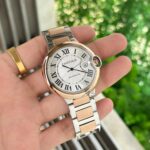 Cartier Ballon Bleu Men’s 42mm with white dial, two-tone stainless steel strap, date counter, and Japanese automatic movement.