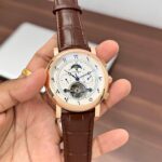 Cartier Open Heart Tourbillon men’s watch. 43mm rosegold case, white dial, leather strap, sun-moon face & Japanese automatic movement.