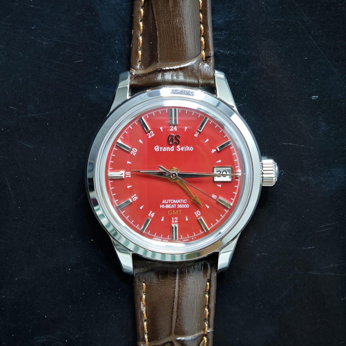 Grand Seiko Hi-Beat 36000 GMT men’s automatic watch with autumn red dial, 39.5mm case, dual time, and Caliber 9S86 movement.
