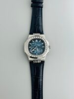 Patek Philippe Nautilus 5712 Silver Blue Dial Men’s Watch featuring 24-hour time, date indicator, sapphire crystal, stainless steel case, and automatic movement with open-back design.